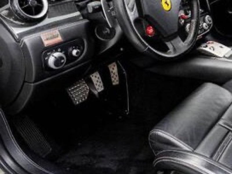 A footwell showing a flat footrest, then brake and throttle pedals, with no clutch